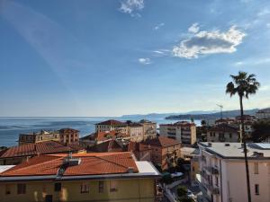 a city with a palm tree and buildings at Appartamento La Casetta in Varazze