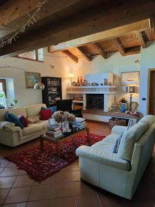 a living room with couches and a table and a fireplace at B&B Ai Castagni in Tenno