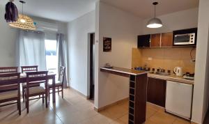 a kitchen and dining room with a table and chairs at Las Tulmas Apartamentos Salta in Salta +40 photos