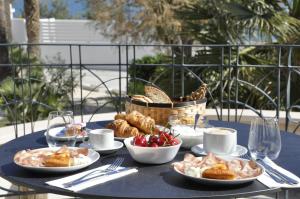 a table with plates of food and a basket of bread at Villa Emy Boutique Bed & Breakfast in Bisceglie