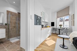 une cuisine et une salle de bain avec douche et table dans l'établissement Ferienwohnung Leichte Brise Westerland auf Sylt, à Westerland