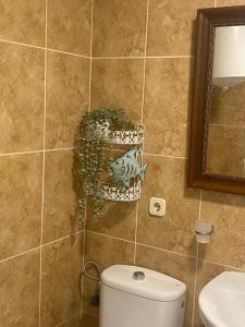 a bathroom with a toilet and a mirror at Light House in Corralejo