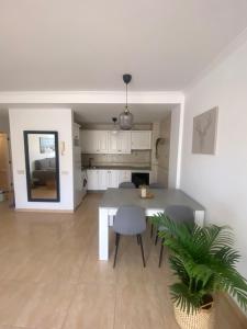 a kitchen and dining room with a table and chairs at Light House in Corralejo