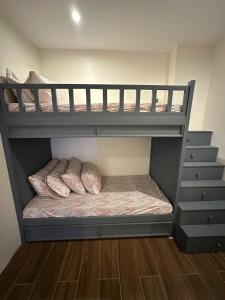 two bunk beds in a room with a staircase at Condo in Davao City in Davao City