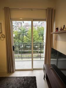 a room with a sliding glass door to a balcony at Condo in Davao City in Davao City +9 photos