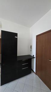 a black desk in a room with a wooden door at Casa Amabile in Como