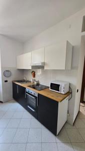a kitchen with a sink and a microwave on a counter at Casa Amabile in Como