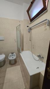 a bathroom with a shower and a tub and a toilet at Casa Amabile in Como
