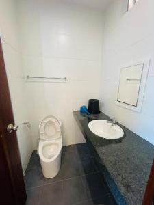 a bathroom with a toilet and a sink at Bay Resort condominium Miri in Miri