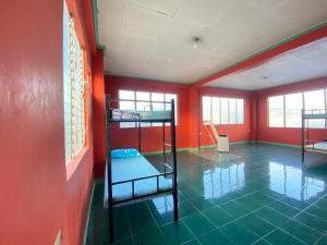 Lapu Lapu CityHostel Home in Lapu-Lapu City的一间红墙房间里有两张双层床