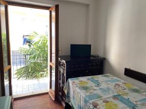 a bedroom with a bed and a sliding glass door at Numana centro, 3 posti aria condizionata pass auto in Numana