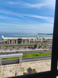 a view of a large building with a parking lot at Delft apartmen Makassar in Tanjungbunga +3 photos