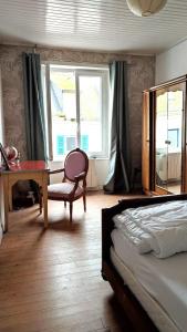 a bedroom with a bed and a desk and window at Maison entière Guilvinec in Le Guilvinec