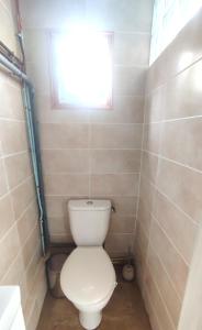 a bathroom with a white toilet and a window at Maison entière Guilvinec in Le Guilvinec +16 photos