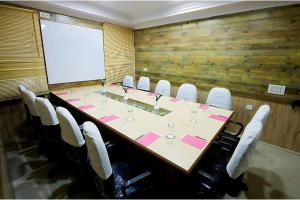 a conference room with a long table and chairs at Hotel High Pointe in Jodhpur