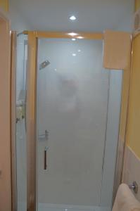 a shower with a glass door in a bathroom at Radcliffe Guest House in Ross on Wye +60 photos