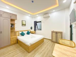 a bedroom with a bed and a table in a room at Urbanest Saigon in Ho Chi Minh City
