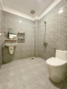 a bathroom with a toilet and a sink at Urbanest Saigon in Ho Chi Minh City