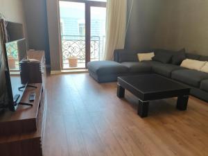 a living room with a couch and a coffee table at Home away home in Mekhrably