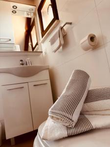 a bathroom with a sink and a toilet with towels at Milton holiday house in Blato +25 photos