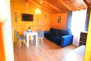 a living room with a couch and a table at Domki Anetta in Dąbki