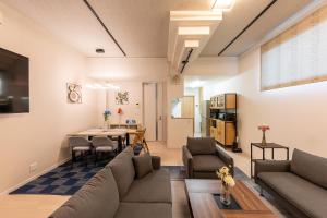 a living room with a couch and a table at The SMILE in Sapporo