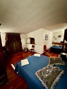 a bedroom with a blue bed in a room at No Vabbè! Penthouse… in Torre Santa Susanna