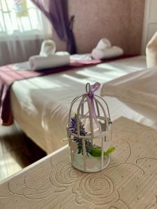 a basket with flowers on a table in a hotel room at Paganino rooms in Fiumicino