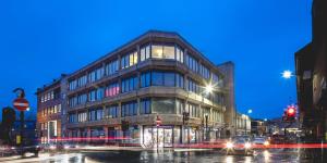 a large building on a city street at night at Central Apartment - Sheffield in Sheffield