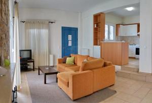 a living room with a couch and a table at Art Lesvos Villa 2 in Pyrgi Thermis