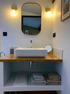 a bathroom with a white sink and a mirror at La Maison VH in Mont-de-Marsan +33 photos