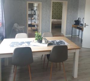 a dining room table with chairs and a plant on it at Bed & Breakfast de Jager in Strömsbruk +18 photos