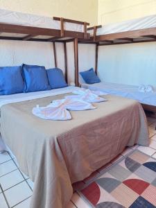 two beds in a room with two bunk beds at Pousada Cores do Pelô in Salvador