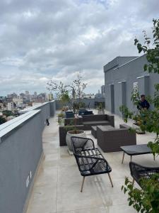 a balcony with chairs and tables on a building at Studio Mobilite in Sao Paulo +47 photos
