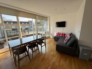 a living room with a table and a couch at Penthouse on the Grange in London