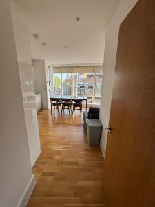 a hallway with a living room with a table and chairs at Penthouse on the Grange in London