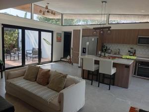 a living room with a couch and a kitchen at Casa Santoni in Quebrada Ganado