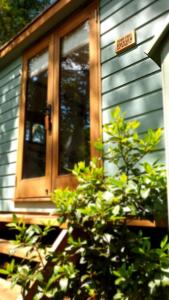 a wooden door on the side of a house at Dowr-Gwel Shepherds Hut in Saint Cleer