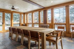 a dining room with a large wooden table and chairs at Apres Lodge 5 Bedroom in Hailey