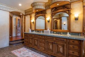 a bathroom with a double sink and a large mirror at Apres Lodge 5 Bedroom in Hailey +48 photos
