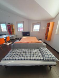 a bedroom with a bed in a room with windows at B&B Casa Sara in Cassano dʼAdda