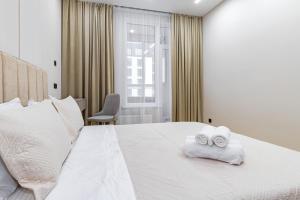 a hotel room with a bed with towels on it at Vivenda in Astana