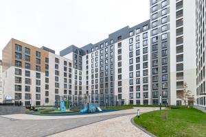 a large building with a playground in front of it at Vivenda in Astana