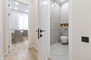 a bathroom with a shower and a toilet and a table at Vivenda in Astana +24 photos