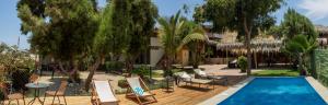 a villa with a swimming pool in a resort at Muelle Viejo Bungalows in Los Órganos