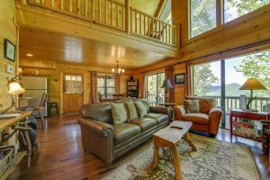 a living room with a couch and a table at Cozy Bryson City Cabin with Mountain Views! in Bryson City