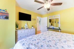 a bedroom with a bed and a ceiling fan at Walk to Beach and Pier Quiet Retreat in Surf City in Surf City
