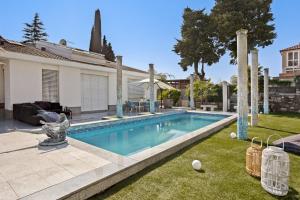 a swimming pool in the yard of a house at Apartmaji Portorož - Portorož Mansion Suites in Portorož