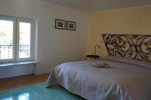 a bedroom with a large bed and a window at Villa Pola Liberty house Mondello in Palermo