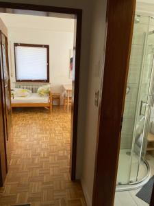 a room with a glass door leading to a living room at Familienzimmer in Neumarkt in der Oberpfalz